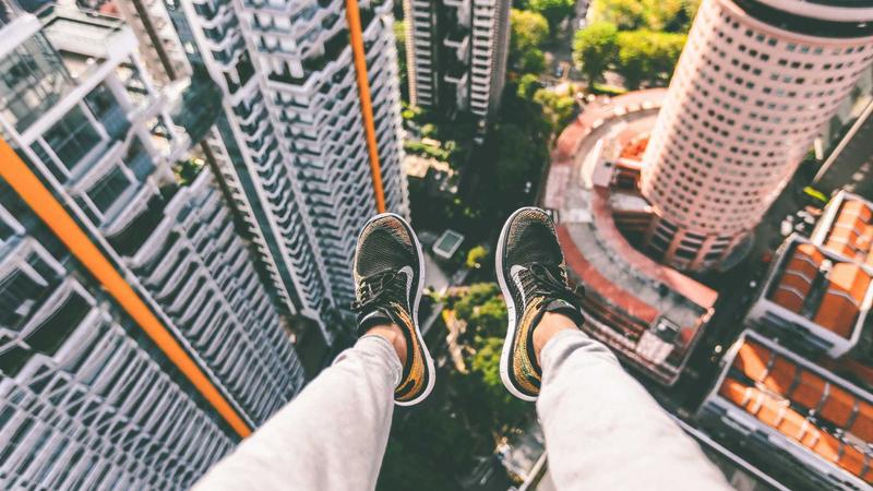Person reviewing credit card statements with laptop
