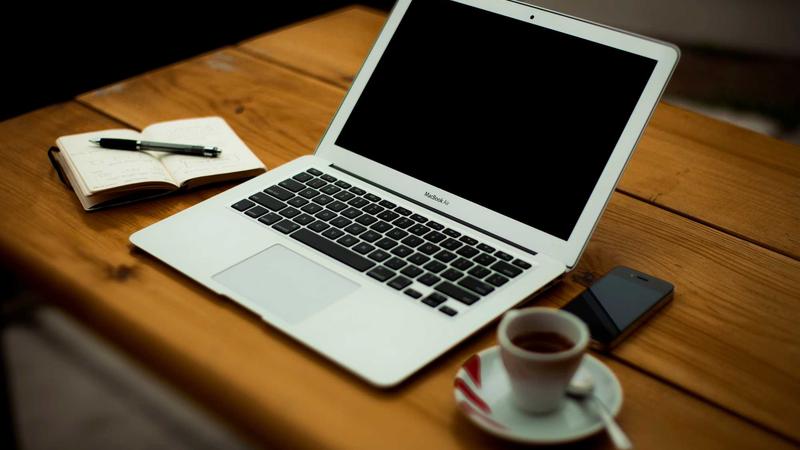 Close-up of credit cards stacked on a wooden table