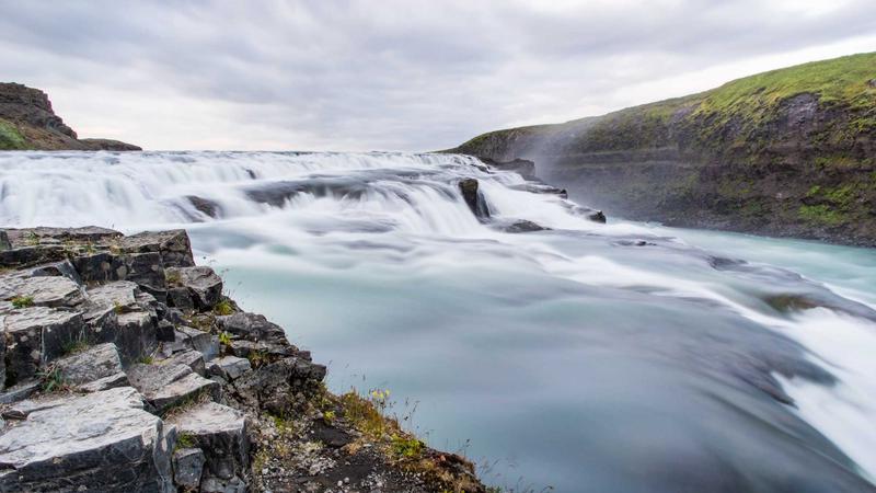Person calculating credit card payments with calculator