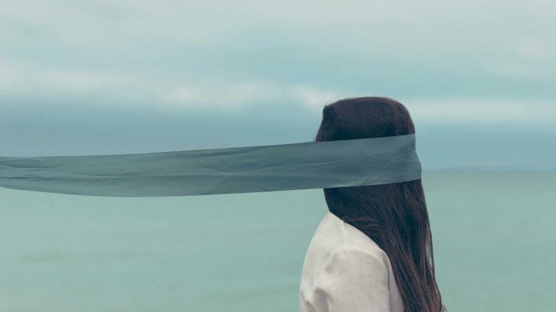 Person comparing credit cards on laptop